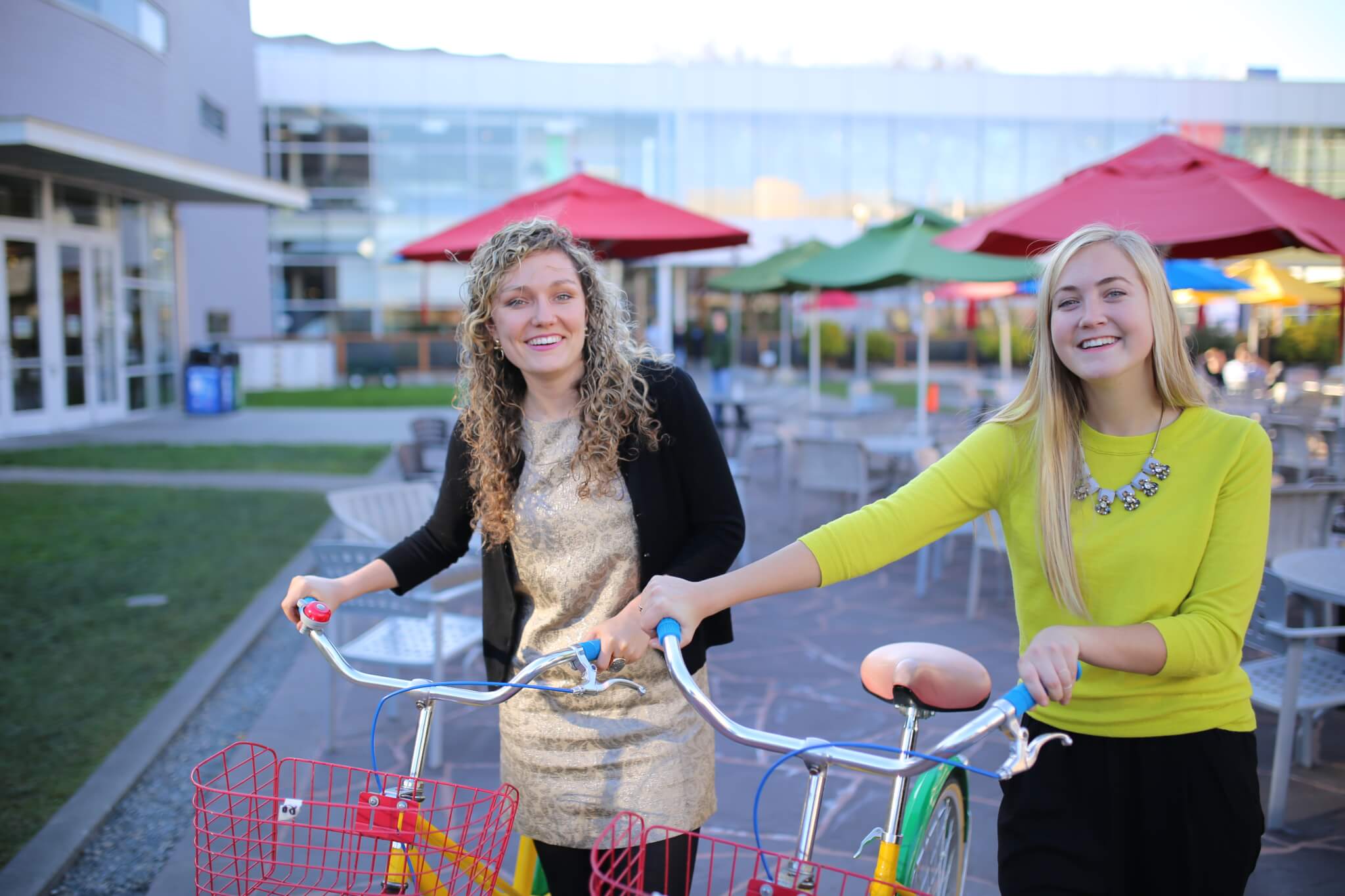 Mackenzie Thomas and Jane Hall stand next to bicycles at the Googleplex in California