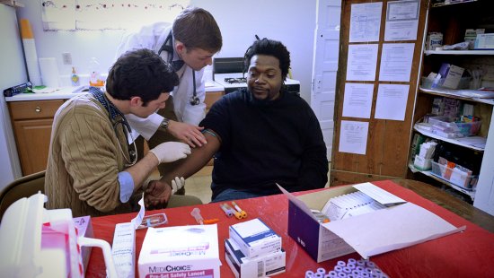 Medical students take a blood sample.