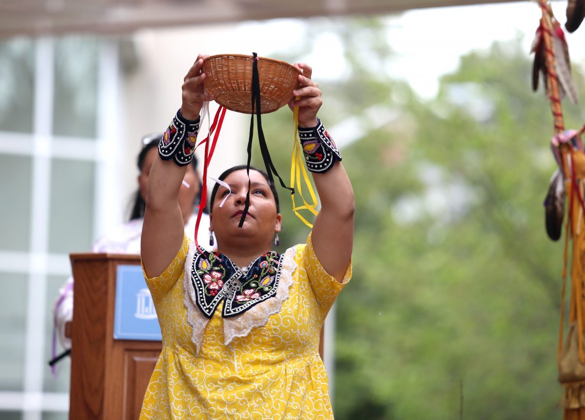 Qua Lynch performs the Corn Harvest Dance during the UNC American Indian Center's rededication of artist Senora Lynch's 