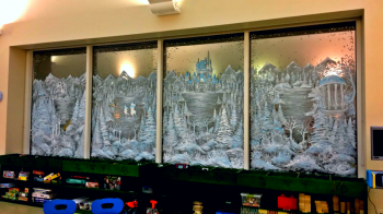 A window is painted with a winter scene.