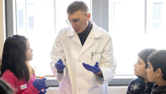 Aziz Sancar performs science experiments with local elementary school students.