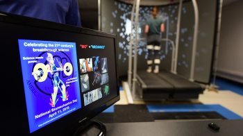 Student walks on a treadmill in a biomehanics lab.