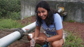 Daira Melendez fills a bottle of water in the Galapagos.