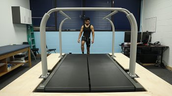 A man walks onto a treadmill.