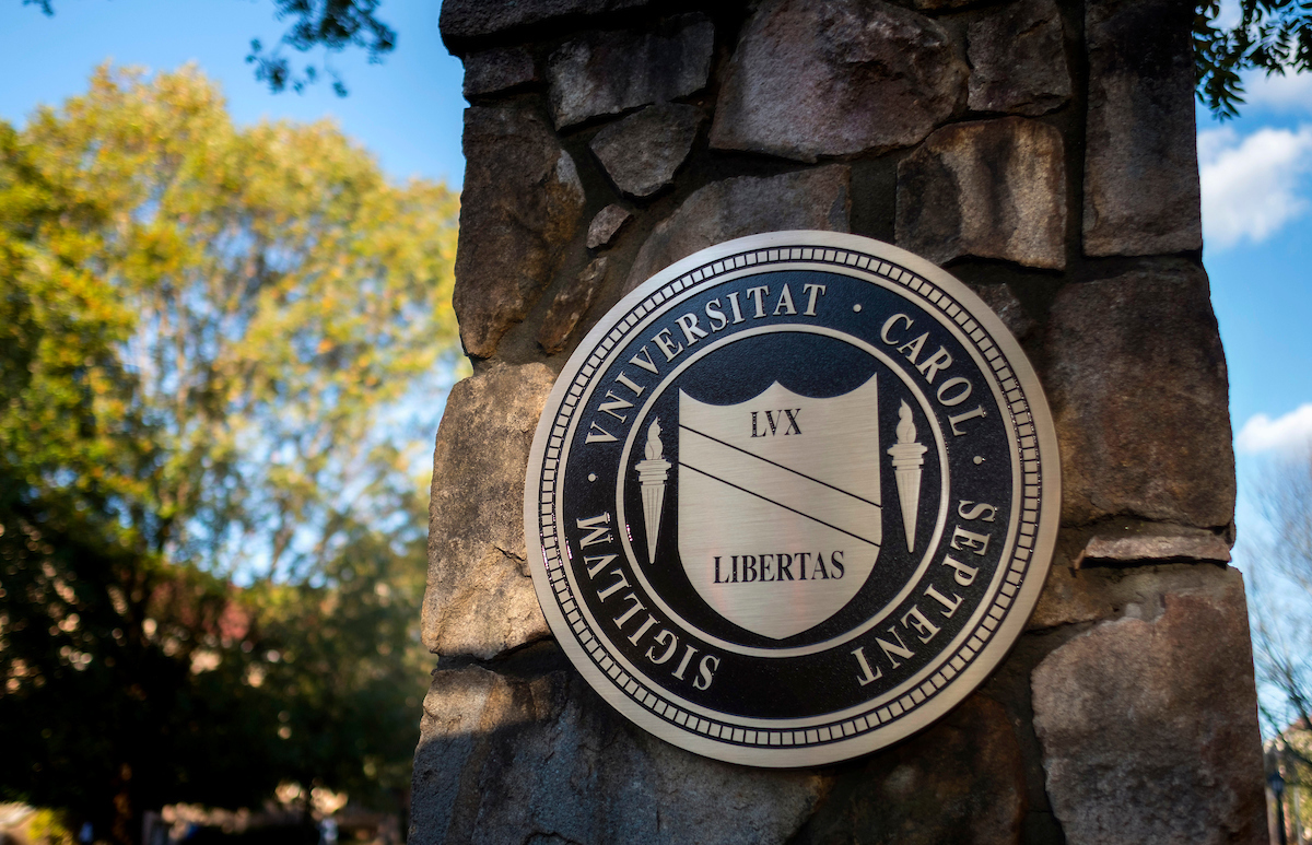 The UNC-Chapel Hill seal on a stone wall.