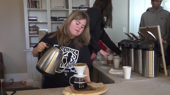 A baristra from Best Buddies Brews pours a cup of coffee.