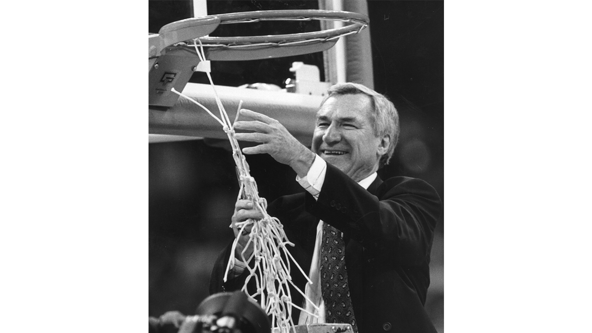 Dean Smith cuts down the net following a national championship game.
