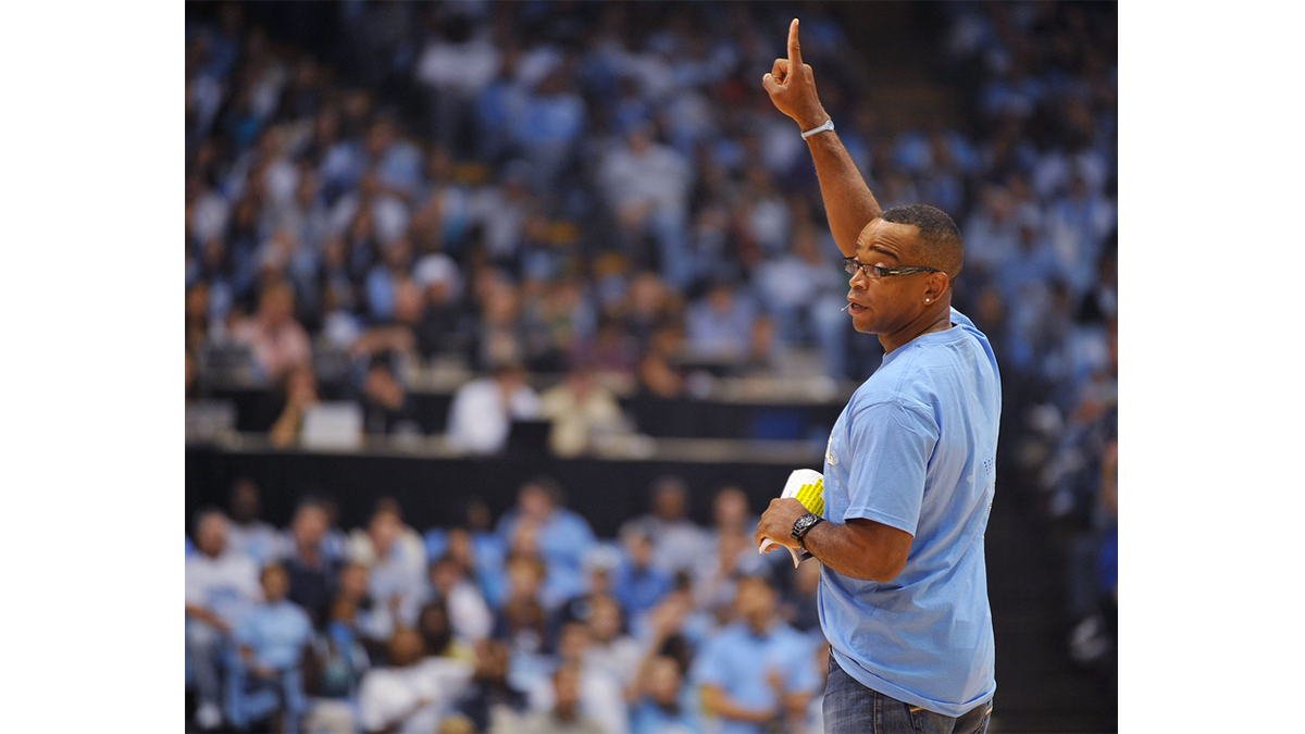 Stuart Scott stands on the court in the Dean Dome.