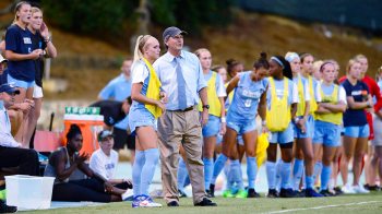 Anson Dorrance coaches from the sidelines.