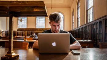 Student works on laptop in library