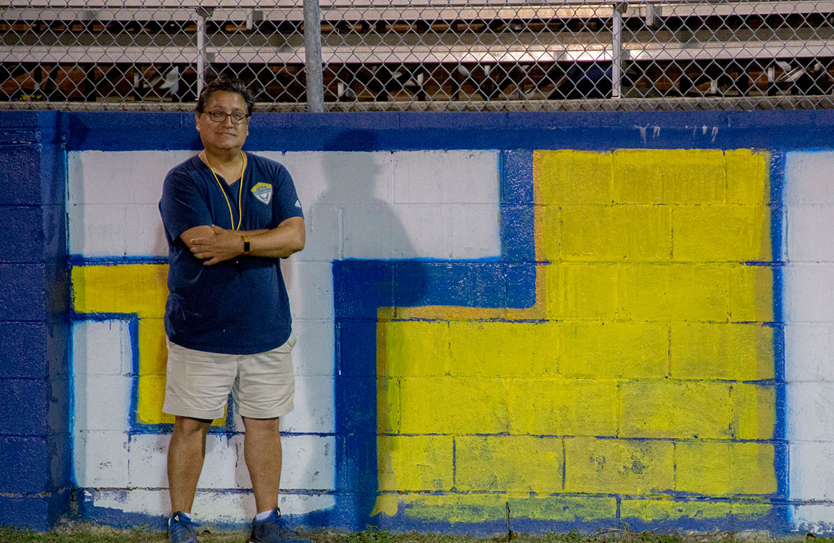 Paul Caudros poses for a photo near a wall