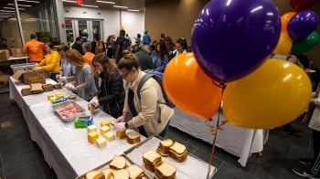 Students make sandwiches during Ramsgiving
