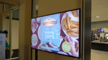 A TV screen that says Mama Dips resturant takeover happening now.