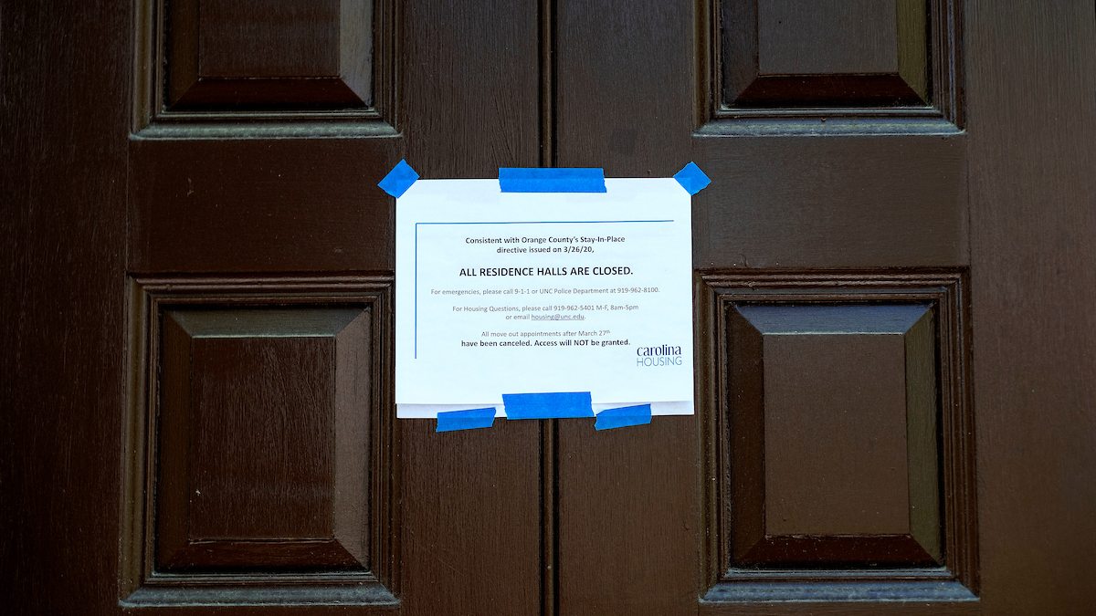 A sign on a door saying that all residence halls are closed.