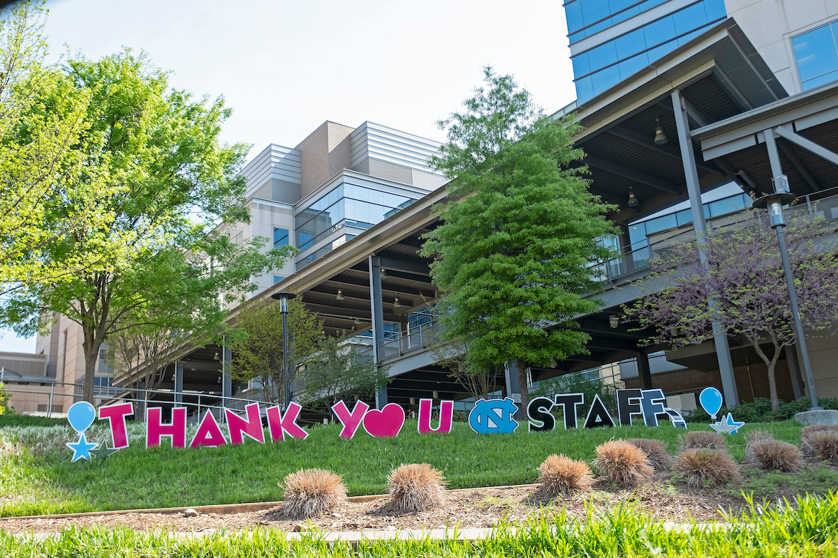 Letters of "Thank you Staff" in the grass. 