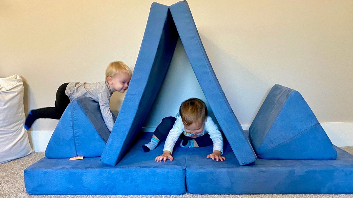 Two children play on a Nugget sofa