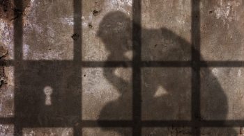 shadow of person thinking in prisons
