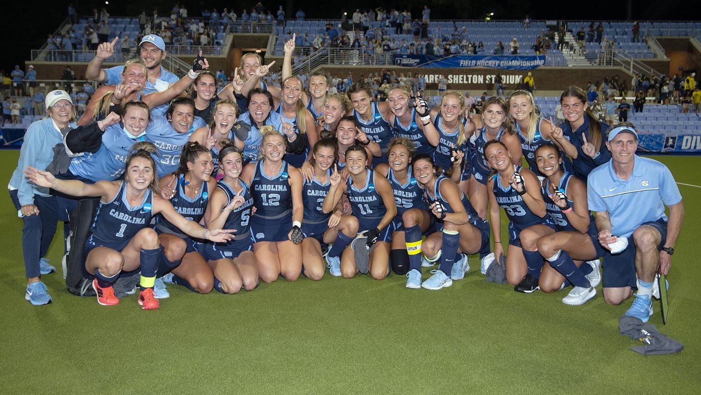 The UNC field hockey team poses for a team photo with the NCAA national championship trophy.