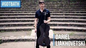 Dariel Laikhovetski standing on a stage with a cello.