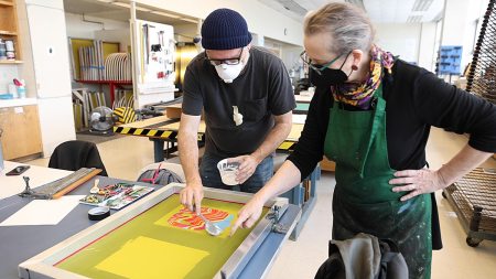 Jason Lord works on a screenprinting board.