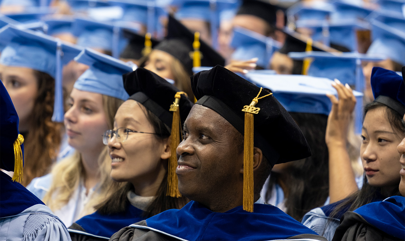 A graduate smiles during the ceremony.