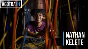 Nathan Kelete looking through a server with cables.
