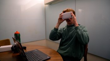 A student looks through a virtual reality viewer.