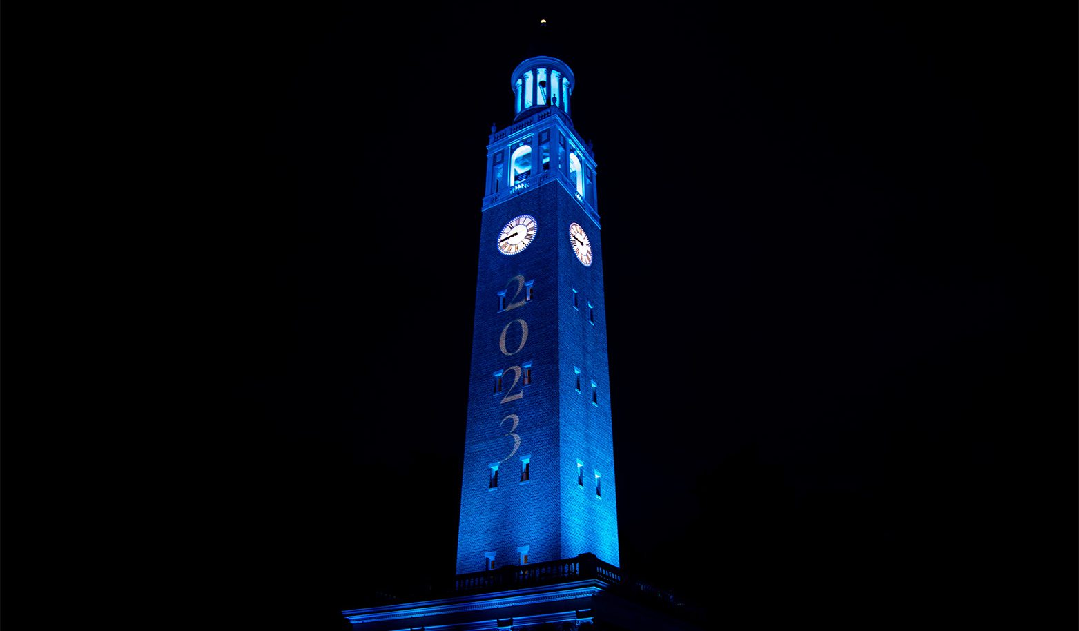 The Bell Tower lit up in Carolina Blue.