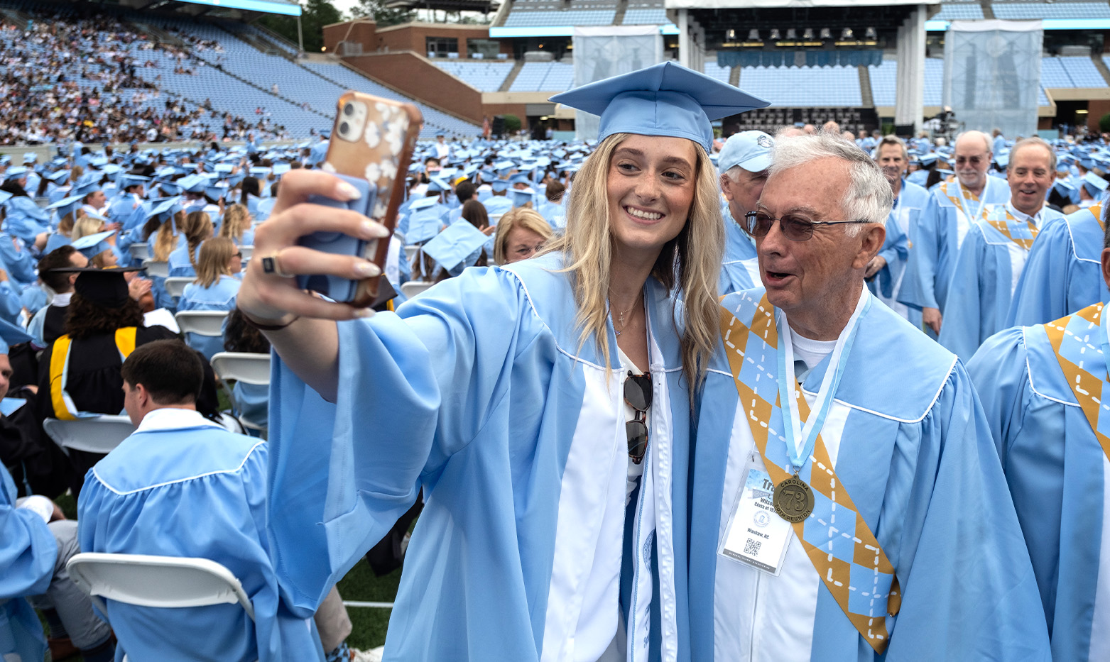 A student takes a photo with a member of the Class of 1973.
