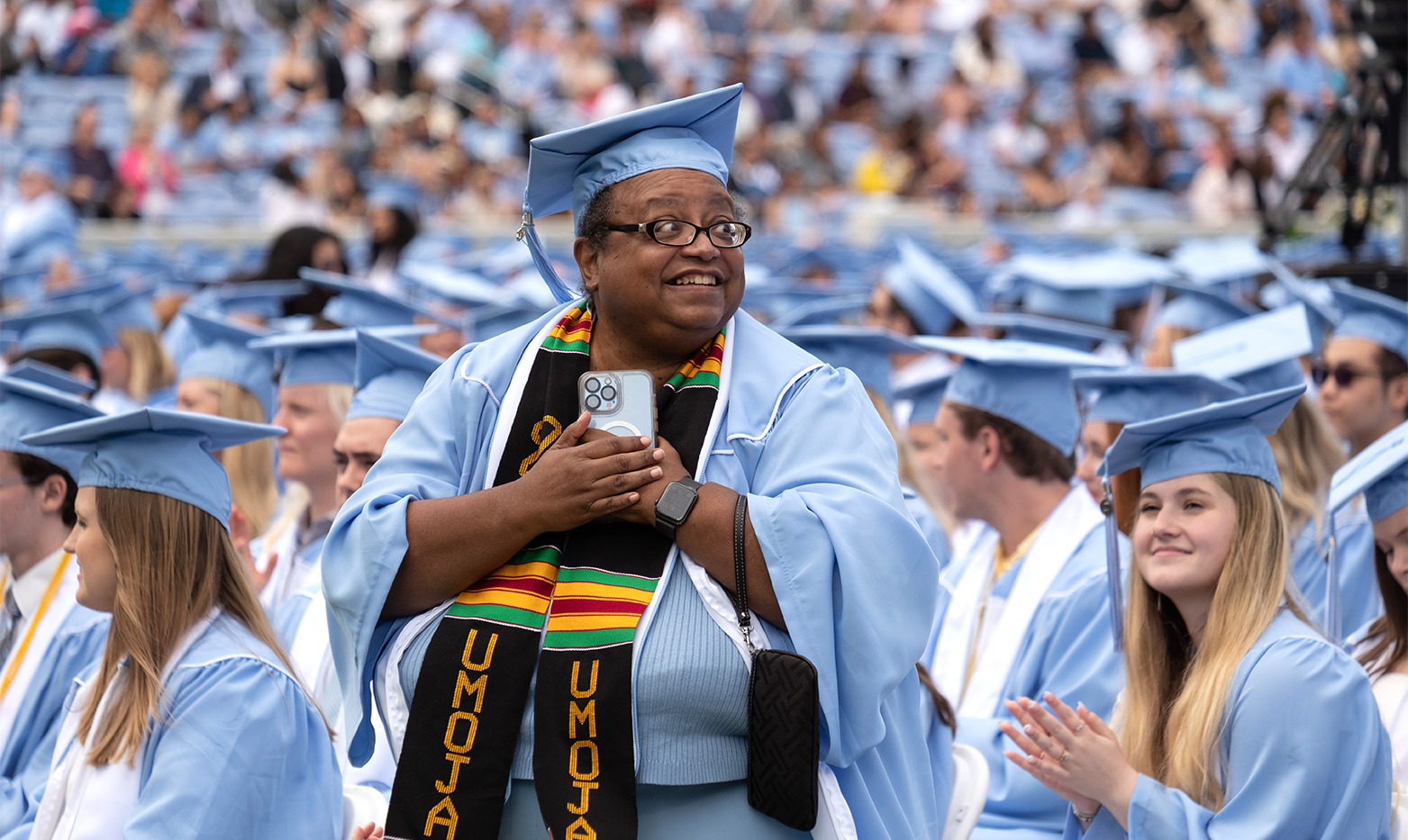 A graduate standing at commencement.