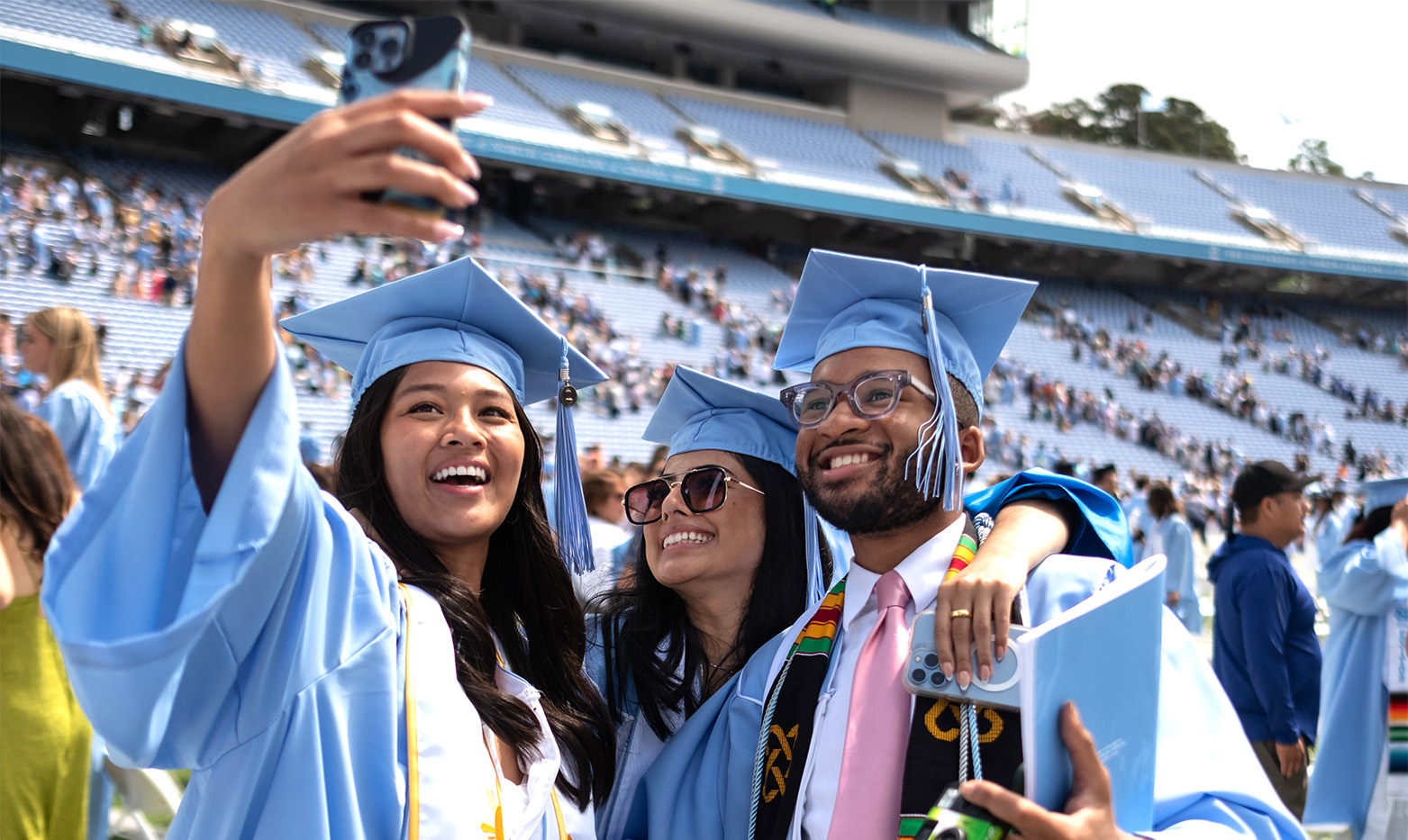 UNC graduates taking a selfie together.