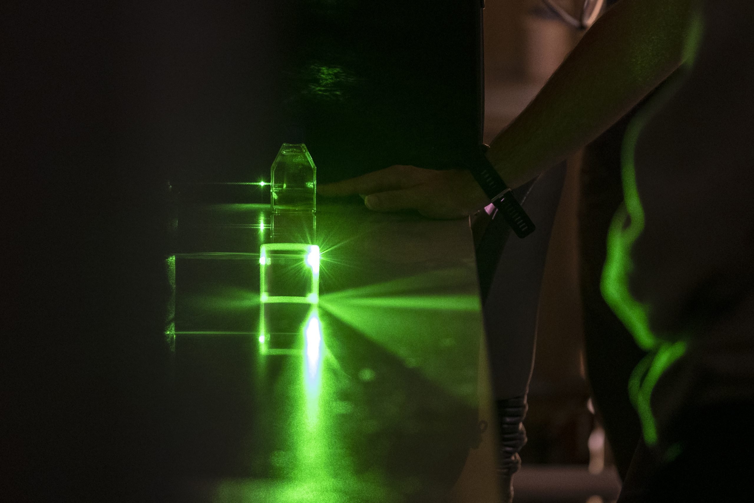 Doctoral student using laser to look at cells