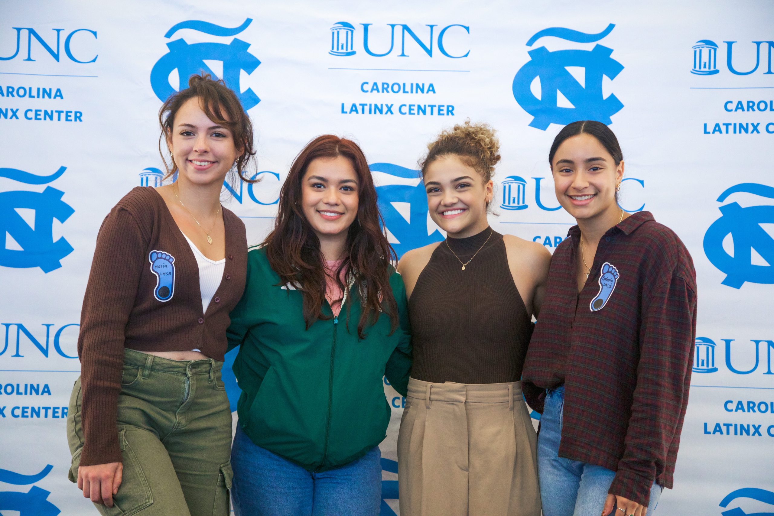 Laurie Hernandez posing with three young women