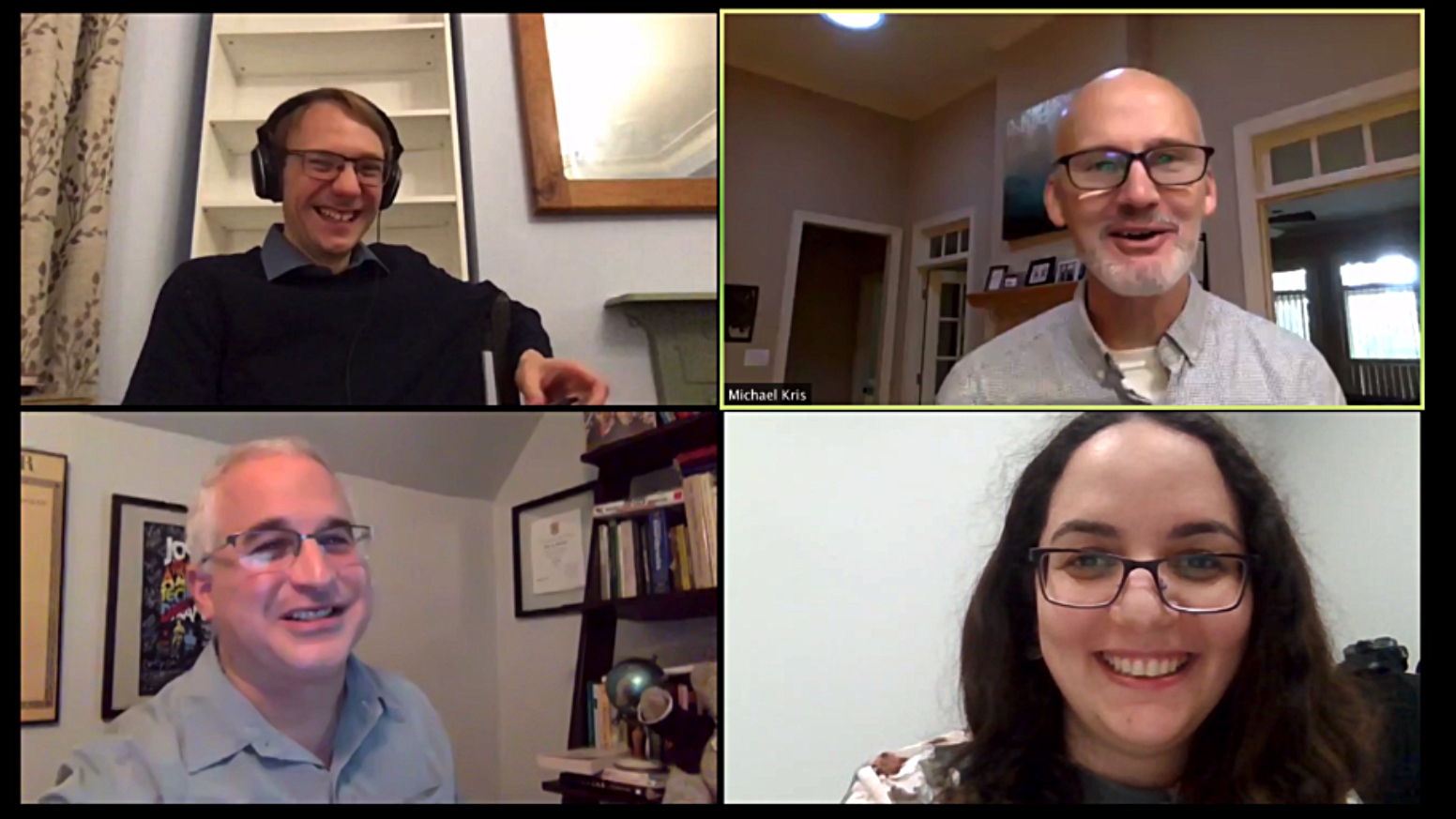 Zoom meeting with four smiling people, three men and one woman.