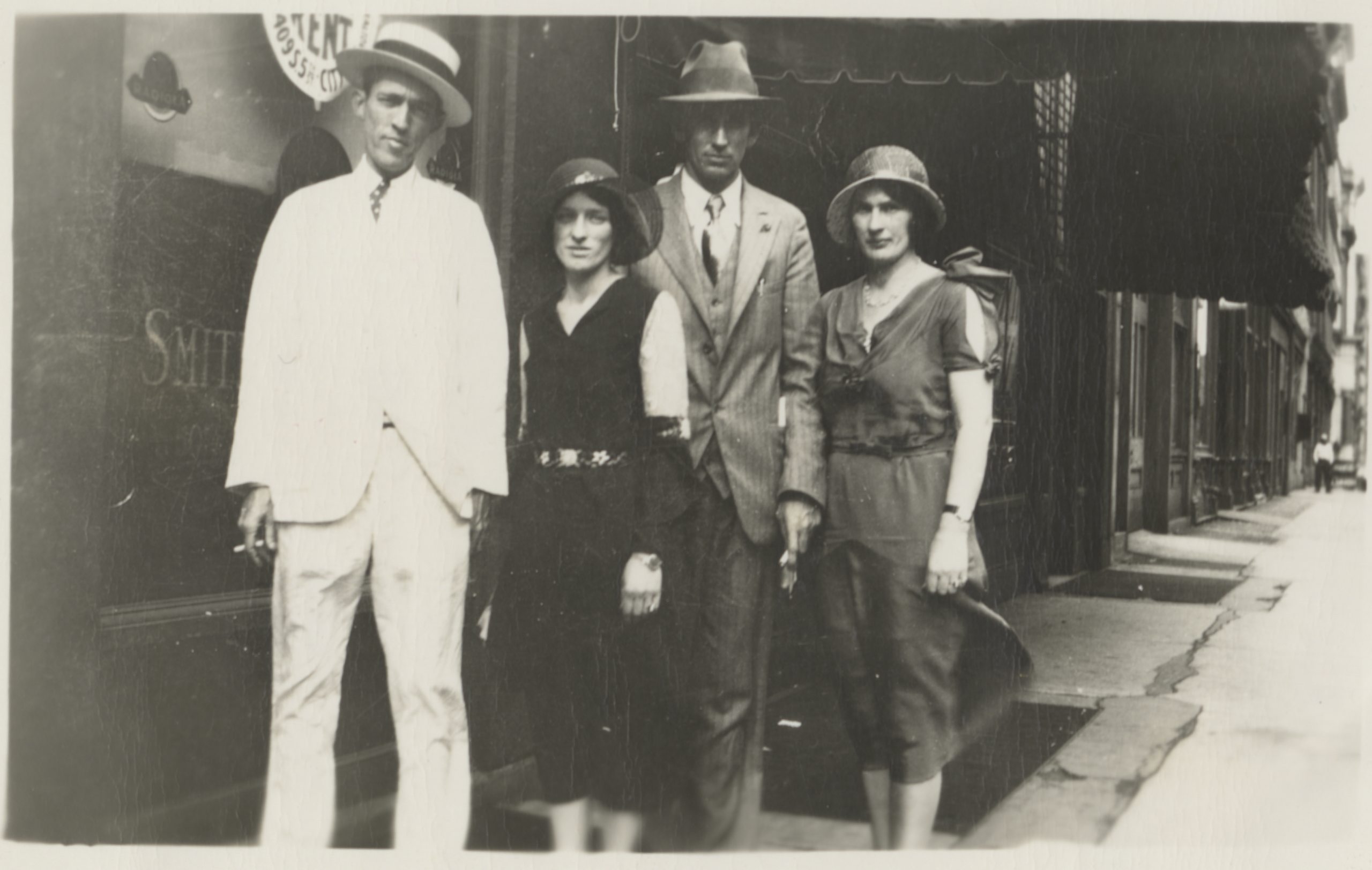 Photo of the first big country music stars Jimmie Rodgers and the Carter Family standing together on a city sidewalk..
