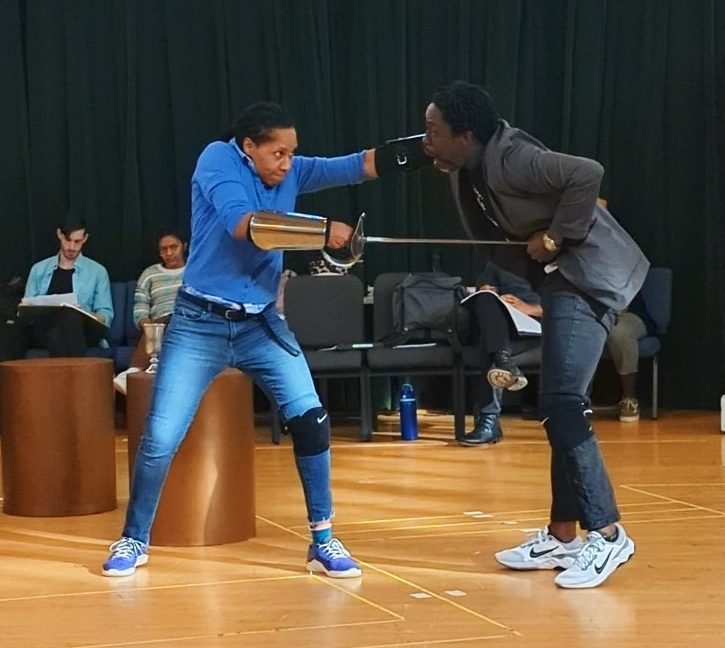 Actors Tia James (Hamlet) and Sekou Laidlow (Claudius) rehearse the sword fight scene for the PlayMakers production.