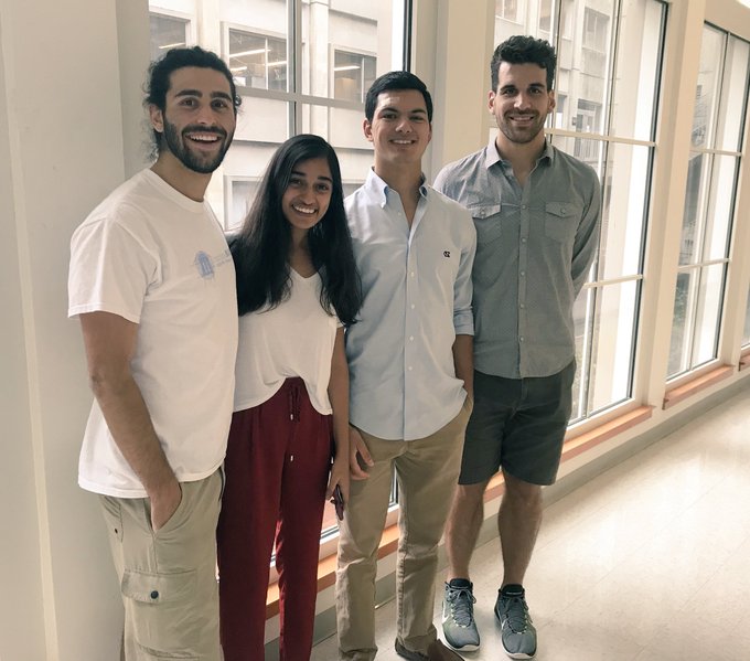 Leibfarth with three undergraduate students at a 2018 symposium.