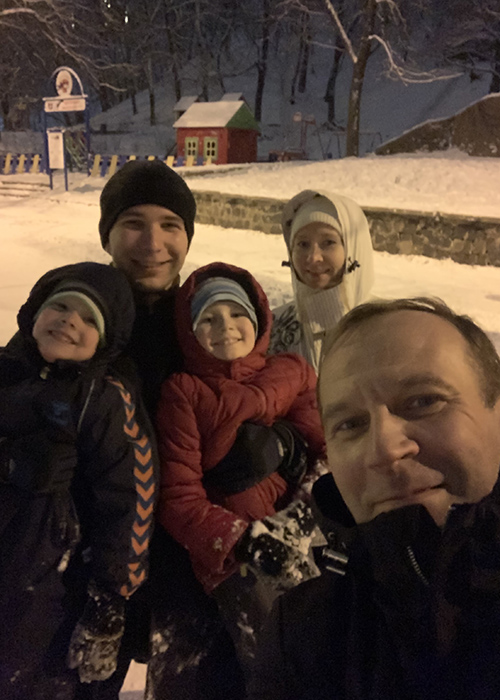 Misha Shvets with his father's family in Ukrainea with snow all around them.