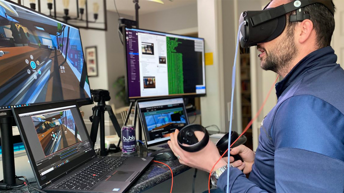 Man with VR headset in front of computer