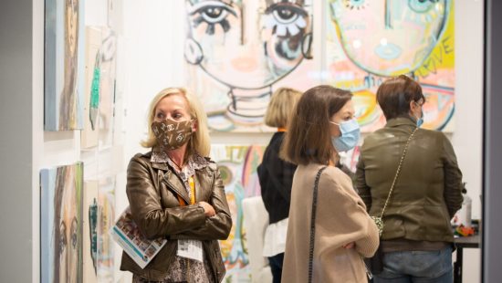 people looking at art with masks on