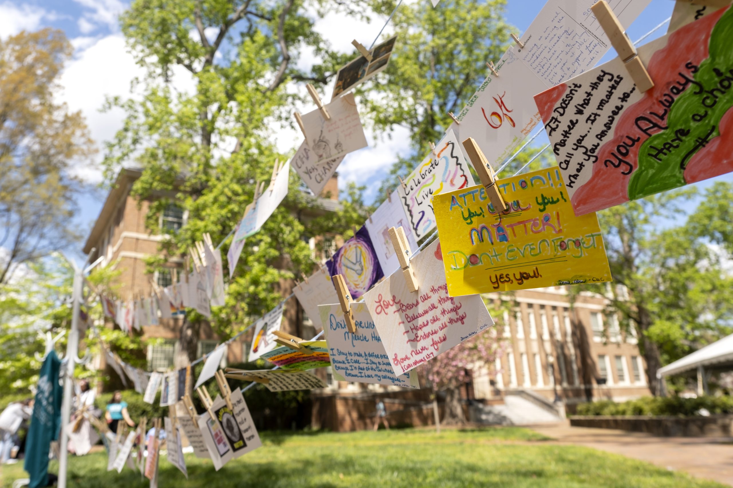 Postcards with messages and art expressing the feelings of Carolina students, faculty and staff hang from yarn during Arts Everywhere Day.