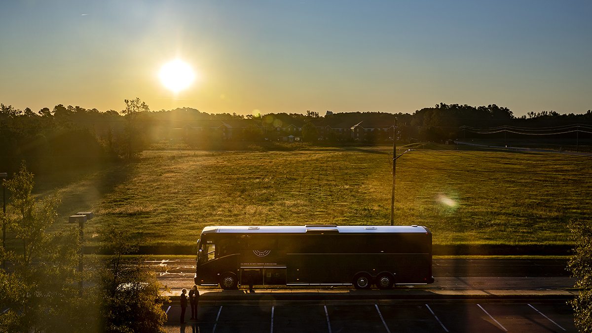 the sun rises as the Tar Heel Bus Tour’s southeast group is about to depart Pembroke