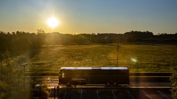 the sun rises as the Tar Heel Bus Tour’s southeast group is about to depart Pembroke