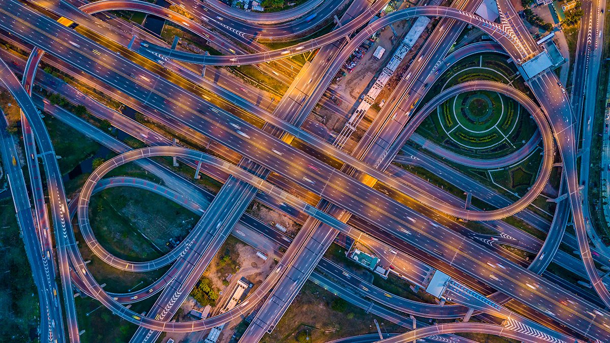 Overhead photo of a highway clover-leaf exchange.