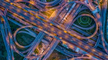 Overhead photo of a highway clover-leaf exchange.