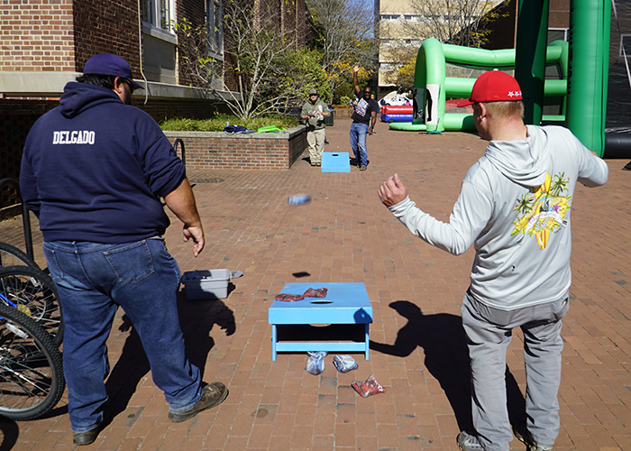 A group of Grounds workers play cornhole outside of Lenoir Hall.