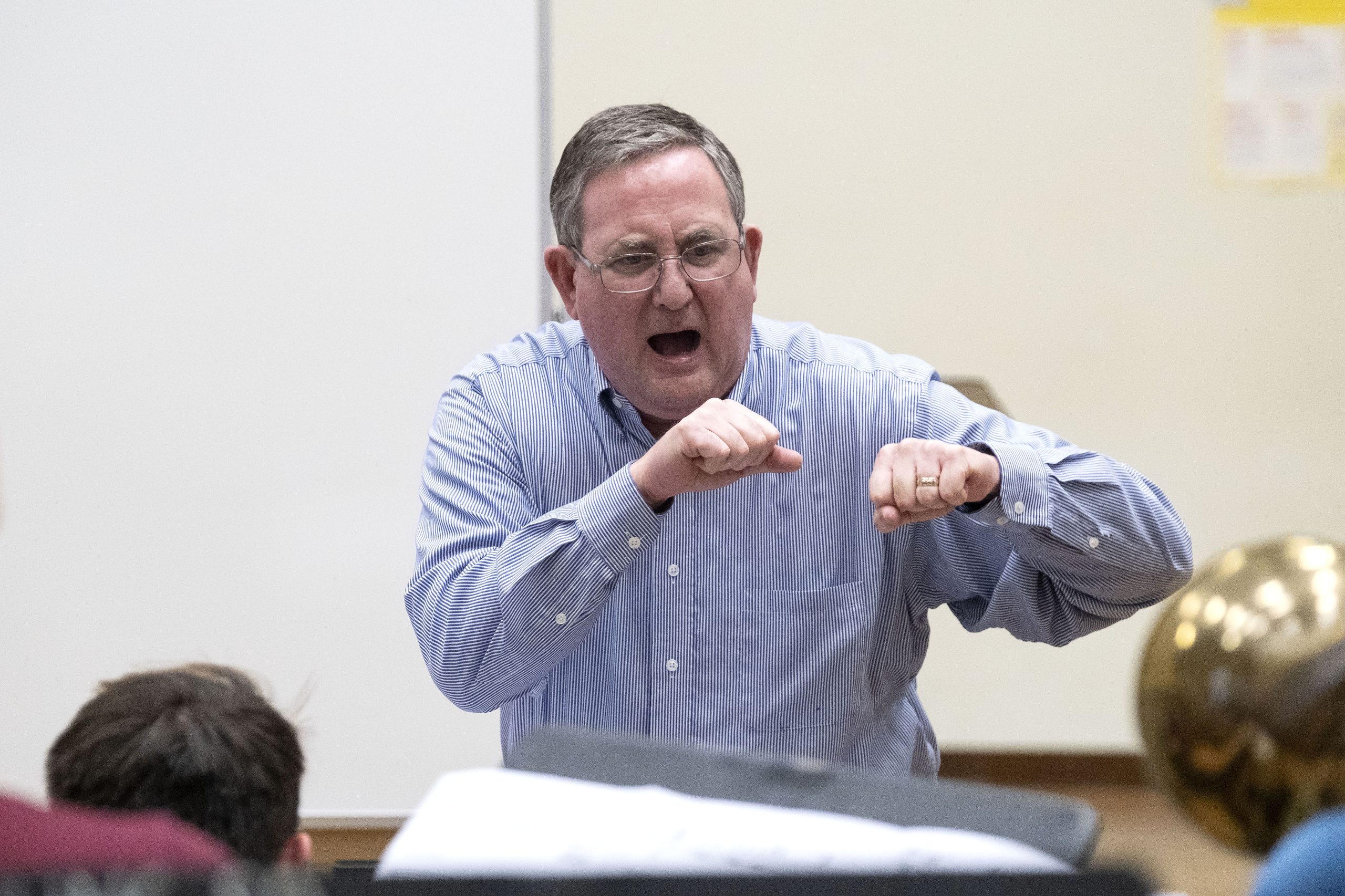 Jim Ketch punches with both hands while directing a rehearsal of the UNC Jazz Ensemble.