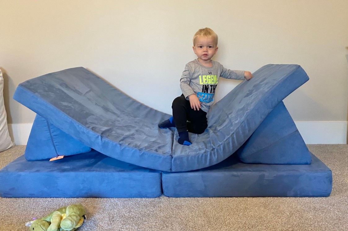 Nineteen-month-old Tobias Krier, the son of Carolina employee Michael Krier and UNC Health employee Paige Krier, plays on his Nugget couch.