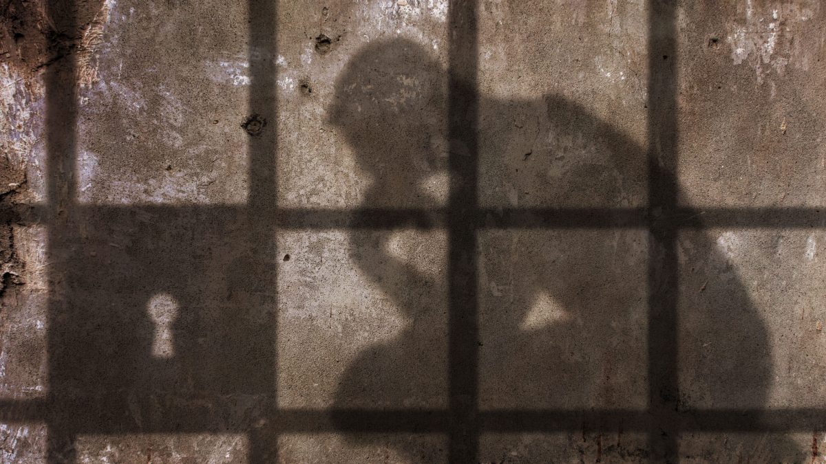 shadow of a person against the wall of a prison