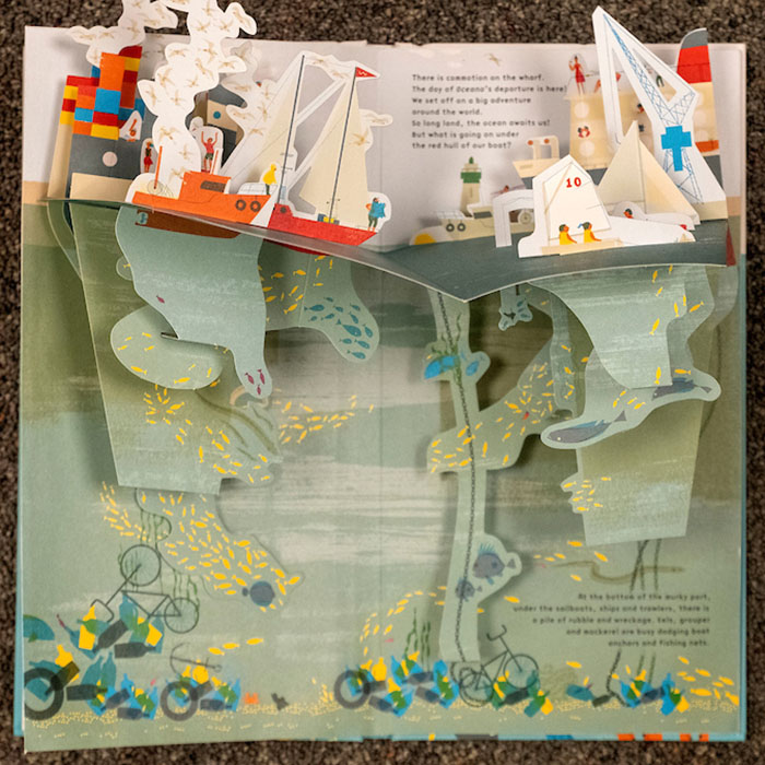 Boats on top of the ocean and strata of plants and sea creatures under in “Under the Ocean” Tate Publishing, 2014. By Anouck Boisrobert and Louis Rigaud.
